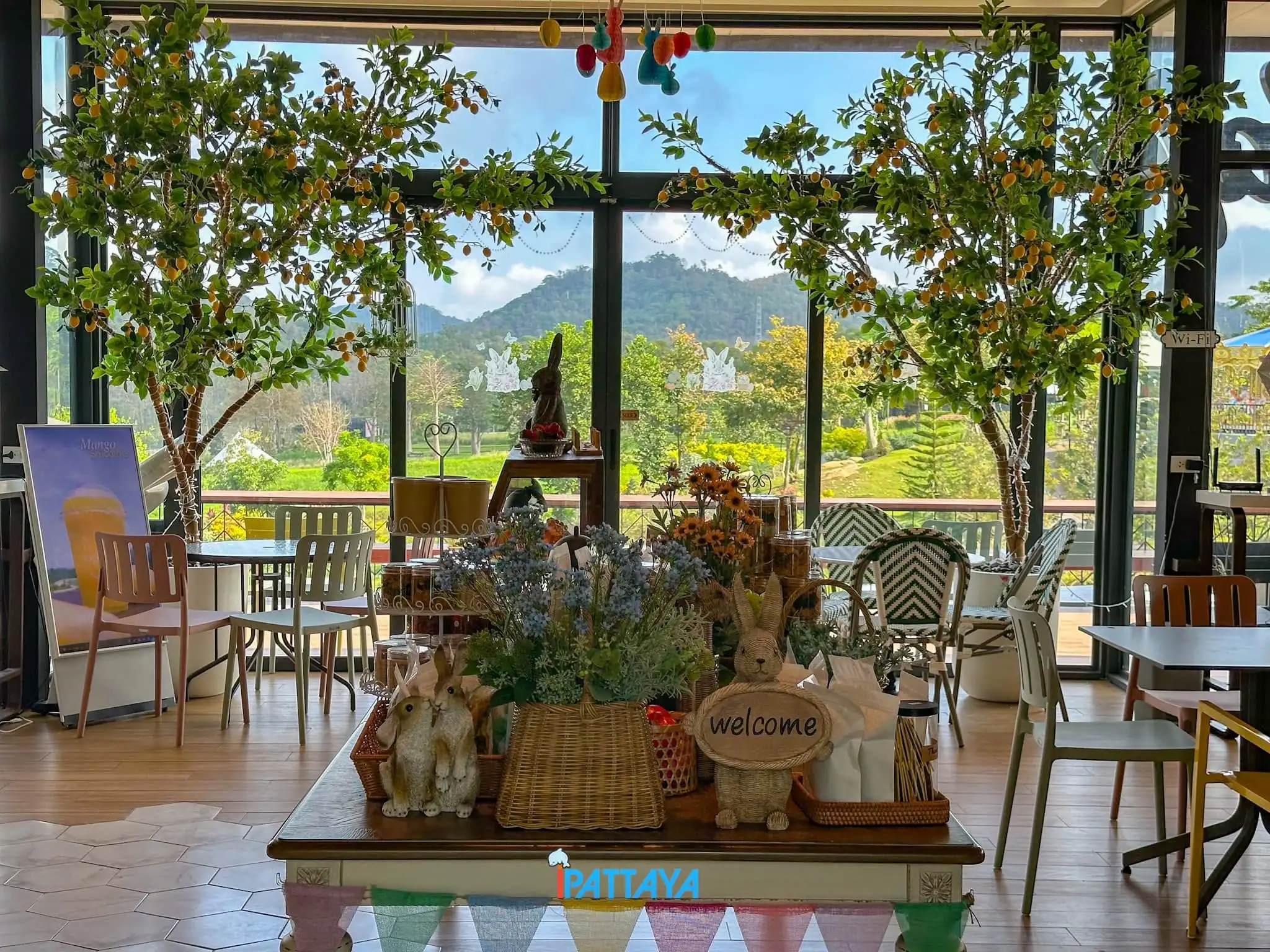 Interior seating with garden and mountain views through large windows